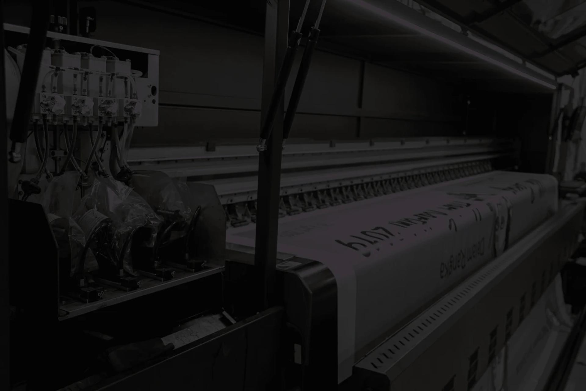 Large format digital printer in operation for commercial printing services at Five D Print